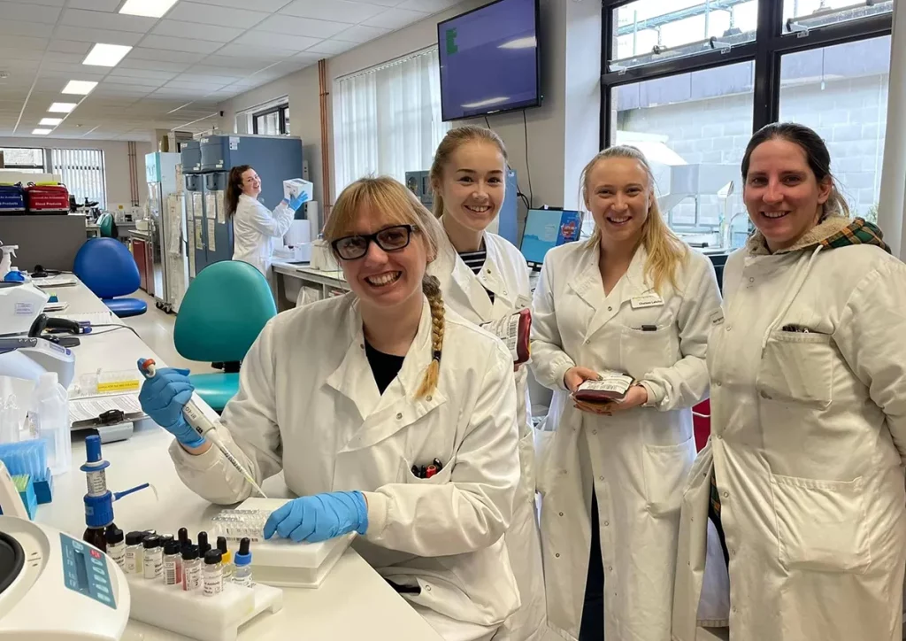 Five healthcare scientists from the Blood Transfusion team in a laboratory setting
