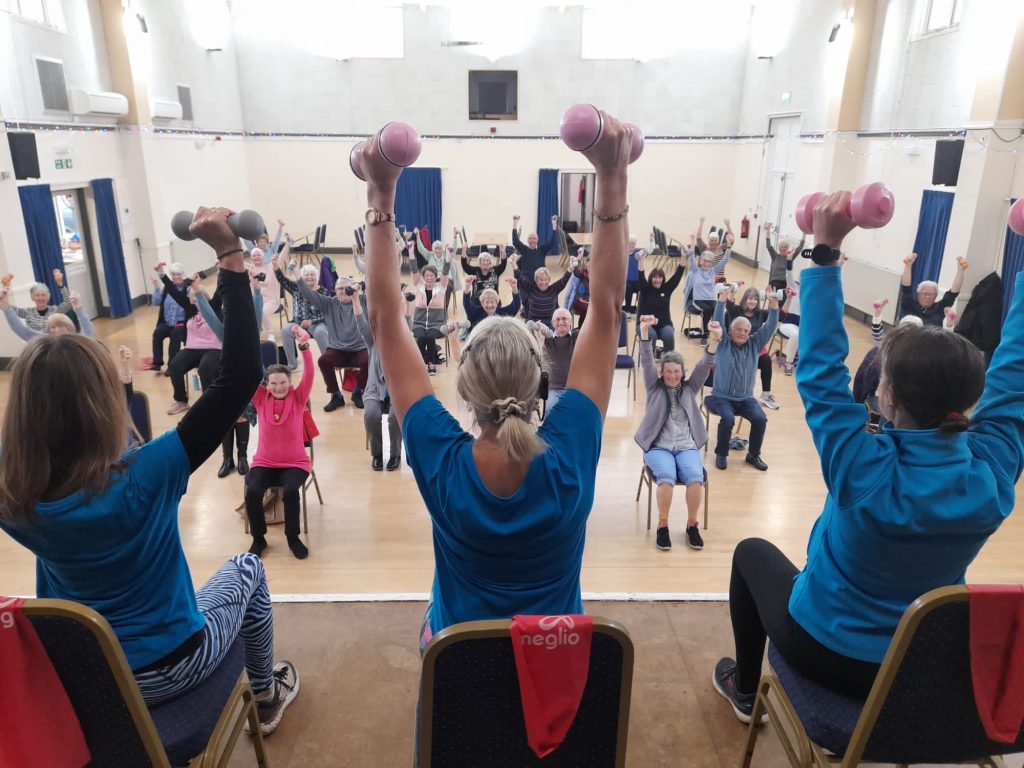 Participants in a Exercise 4 Mobility class in Bude lift their dumbbells