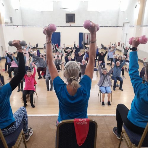 Participants in a Exercise 4 Mobility class in Bude lift their dumbbells