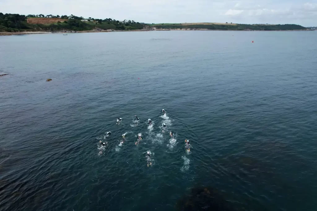 photo depicting open sea swimmers crossing Falmouth Bay